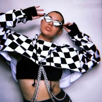 a woman in a black and white checkered jacket posing for a photo