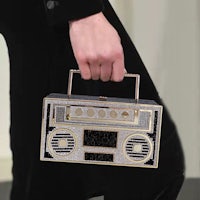 a woman is holding a bag with a radio on it